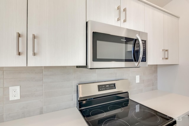 kitchen with tasteful backsplash and stainless steel appliances