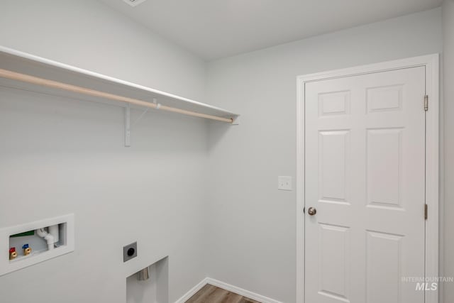 clothes washing area featuring laundry area, baseboards, wood finished floors, washer hookup, and electric dryer hookup