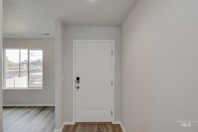 interior space with light wood-style floors, visible vents, and baseboards