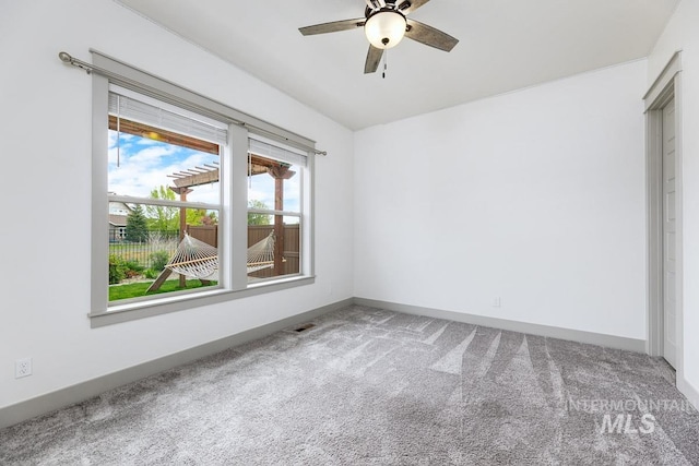 unfurnished bedroom with a ceiling fan, baseboards, visible vents, and carpet