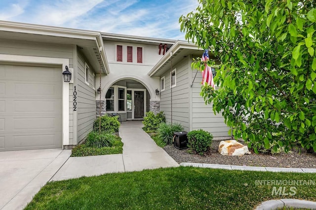 view of exterior entry featuring an attached garage