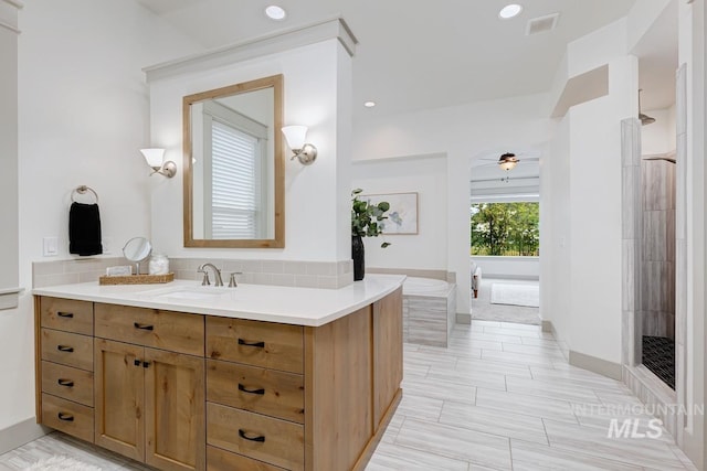 bathroom featuring vanity, a ceiling fan, recessed lighting, and tiled shower