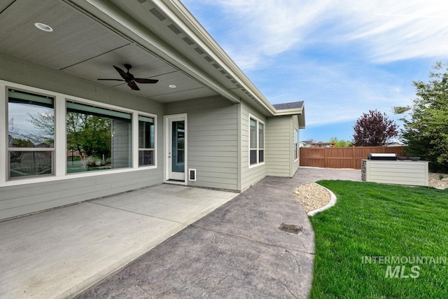 view of patio featuring fence and ceiling fan
