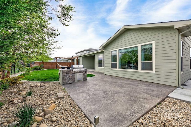 back of house with a patio area, fence, a yard, and area for grilling