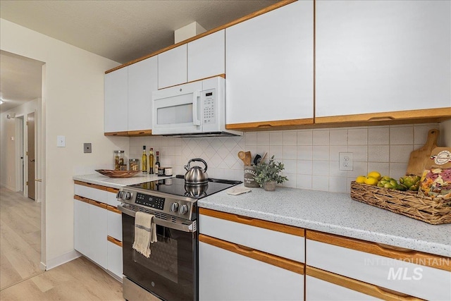 498 E Chester Ln, Boise, ID 83706 - kitchen with stainless steel electric range oven, white microwave, light wood finished floors, and white cabinetry