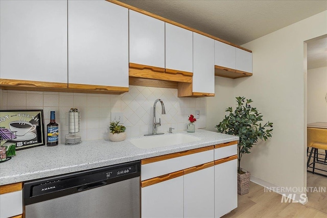 498 E Chester Ln, Boise, ID 83706 - kitchen featuring dishwasher, a sink, white cabinets, light wood-style flooring, and tasteful backsplash