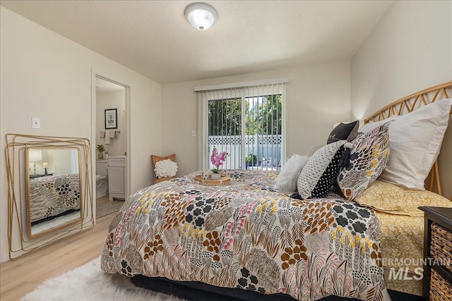 498 E Chester Ln, Boise, ID 83706 - bedroom with light wood finished floors, access to exterior, and connected bathroom