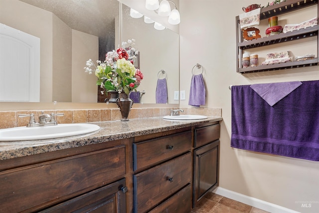 1020 Woodland St, Rupert, ID 83350 - bathroom featuring double vanity and baseboards