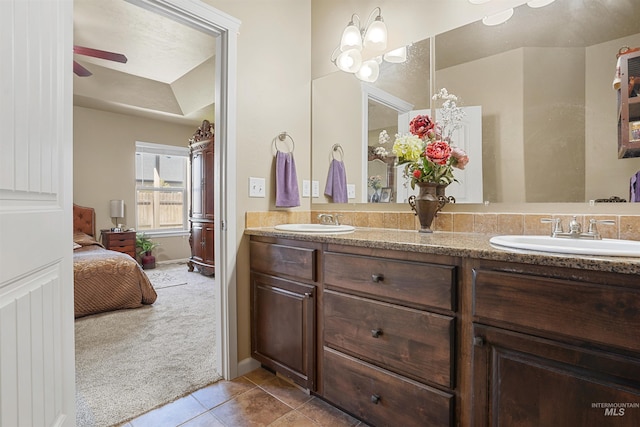 1020 Woodland St, Rupert, ID 83350 - bathroom with double vanity, tile patterned floors, connected bathroom, ceiling fan, and baseboards