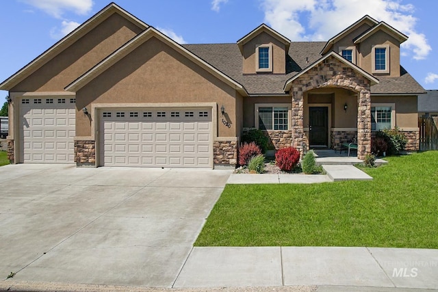 1020 Woodland St, Rupert, ID 83350 - view of front of property featuring stone siding, stucco siding, an attached garage, and driveway