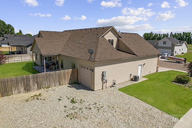 1020 Woodland St, Rupert, ID 83350 - view of property exterior with a garage, a residential view, a shingled roof, and central AC