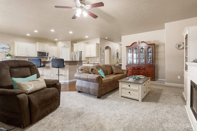 1020 Woodland St, Rupert, ID 83350 - living area with ceiling fan, recessed lighting, arched walkways, a fireplace, and baseboards