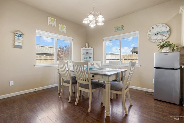 1020 Woodland St, Rupert, ID 83350 - dining room featuring a chandelier, dark wood-style floors, and baseboards