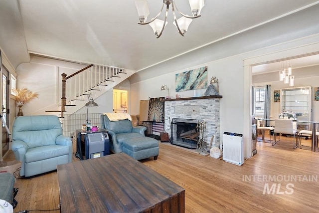 937 SW 1st St, Ontario, OR 97914 - living room featuring a chandelier, wood finished floors, stairs, and a fireplace