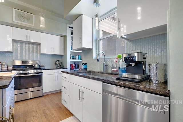 937 SW 1st St, Ontario, OR 97914 - kitchen with appliances with stainless steel finishes, tasteful backsplash, white cabinets, and dark stone countertops