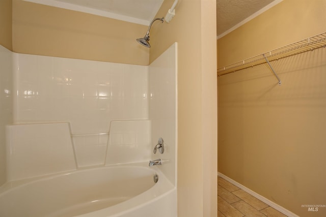 full bathroom featuring tub / shower combination and baseboards