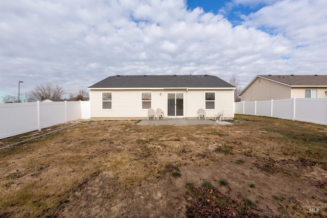 back of property featuring a yard, a fenced backyard, and a patio area