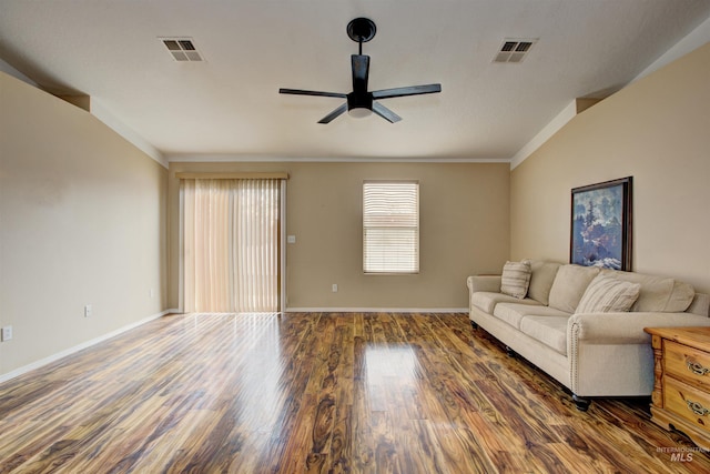 unfurnished living room featuring baseboards, wood finished floors, visible vents, and ceiling fan