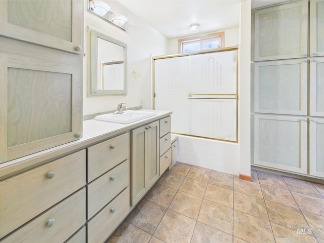 full bathroom featuring shower / bath combination, stone finish floor, and vanity
