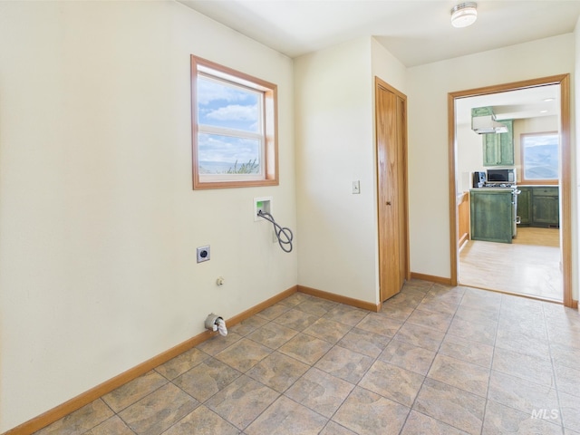 washroom with a healthy amount of sunlight, washer hookup, hookup for an electric dryer, and baseboards