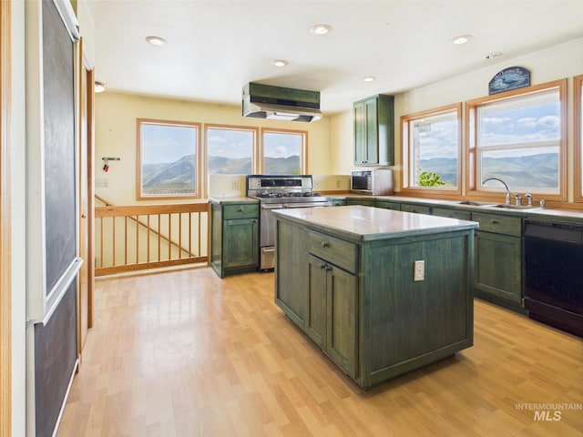 kitchen with stainless steel appliances, extractor fan, a sink, and green cabinets