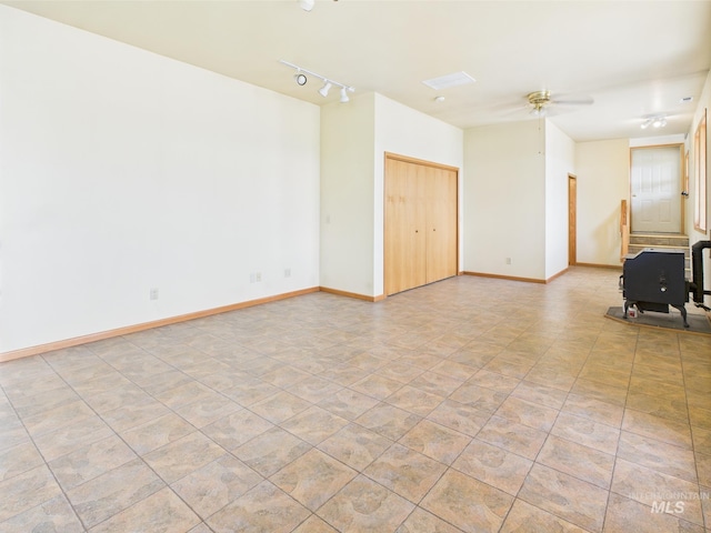 unfurnished room with baseboards, a ceiling fan, and rail lighting