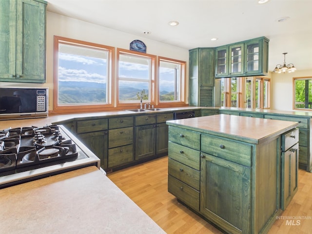 kitchen featuring light wood-style flooring and green cabinets