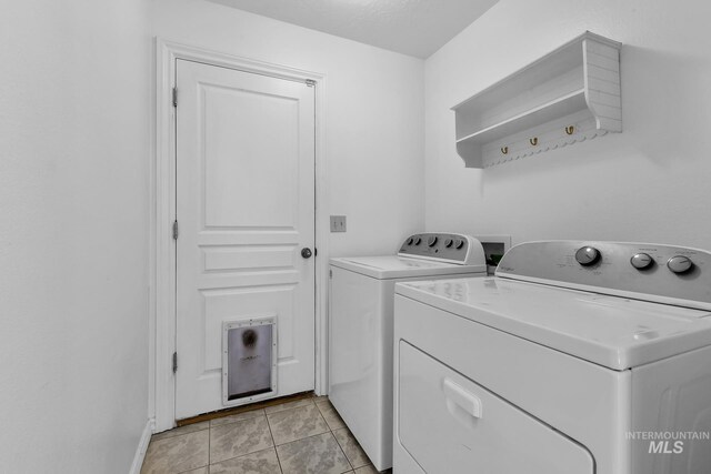 1295 NE Blossom, Mountain Home, ID 83647 - washroom featuring separate washer and dryer, light tile patterned floors, and baseboards