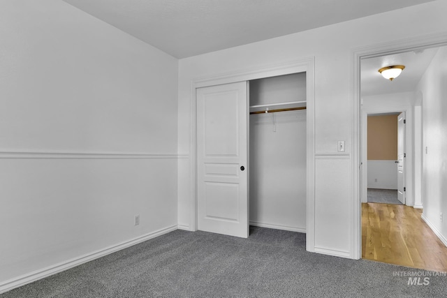 1295 NE Blossom, Mountain Home, ID 83647 - unfurnished bedroom featuring carpet floors, a closet, and baseboards