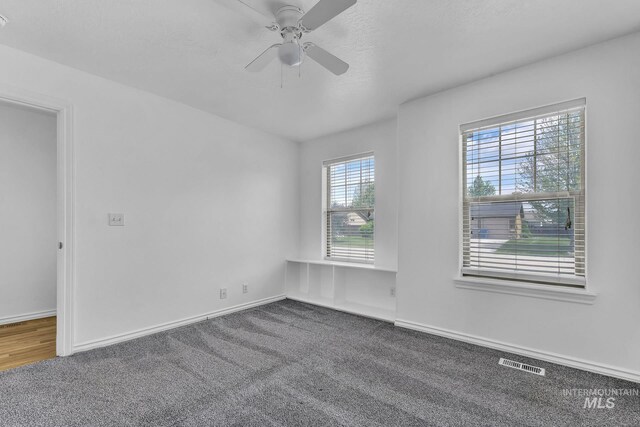 1295 NE Blossom, Mountain Home, ID 83647 - carpeted spare room featuring a ceiling fan and baseboards