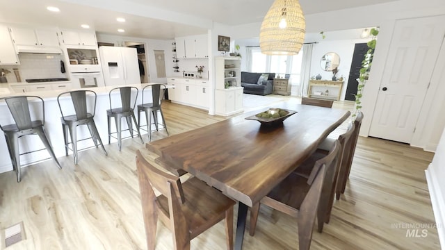 7985 S Cloverdale Rd, Boise, ID 83709 - dining room with recessed lighting, visible vents, light wood finished floors, and an inviting chandelier
