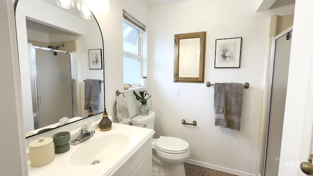 7985 S Cloverdale Rd, Boise, ID 83709 - bathroom featuring toilet, baseboards, vanity, and a stall shower