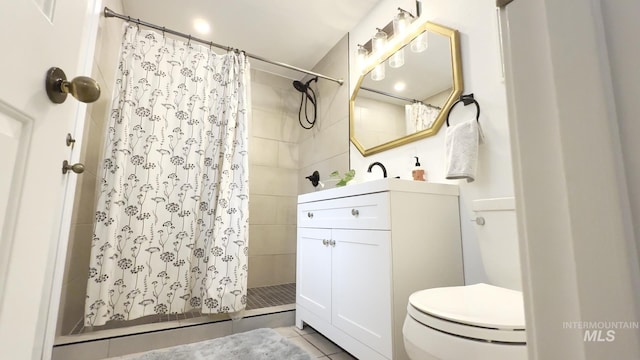 7985 S Cloverdale Rd, Boise, ID 83709 - bathroom featuring a tile shower, toilet, vanity, and tile patterned floors