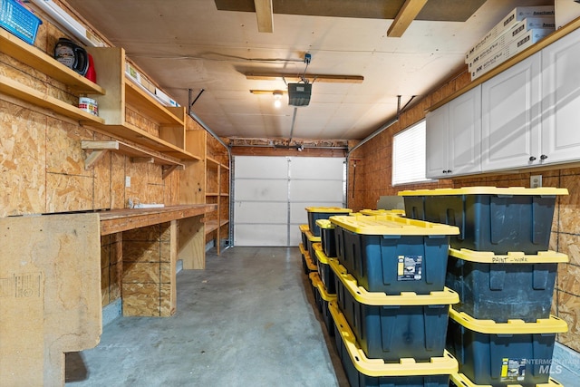 garage featuring a garage door opener and a workshop area