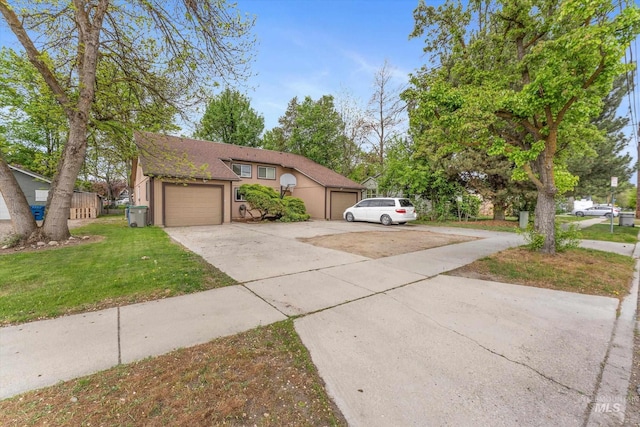 view of front of house featuring a garage, driveway, a front lawn, and stucco siding