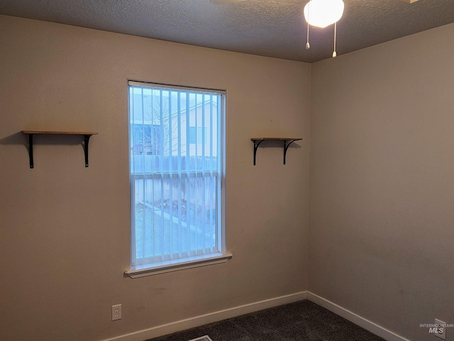 empty room featuring carpet flooring and a textured ceiling