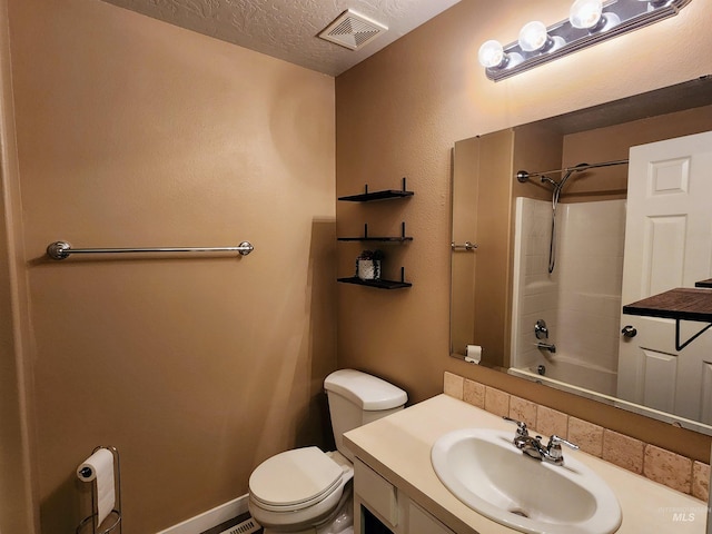 full bathroom featuring vanity, a textured ceiling, toilet, and  shower combination