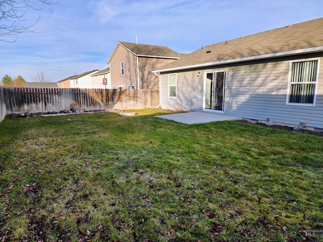 rear view of house featuring a yard and a patio