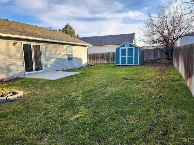 view of yard featuring a storage unit and a patio