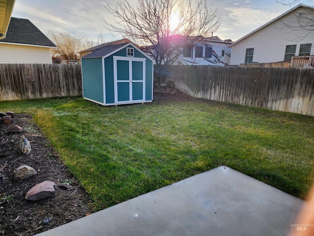 yard at dusk with a storage shed