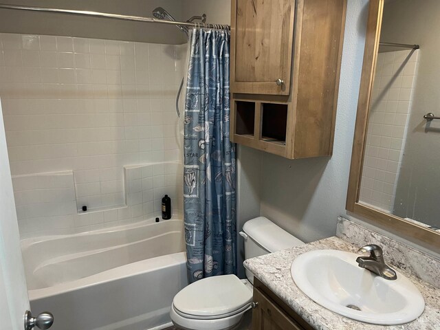 full bathroom featuring vanity, shower / bath combination with curtain, and toilet