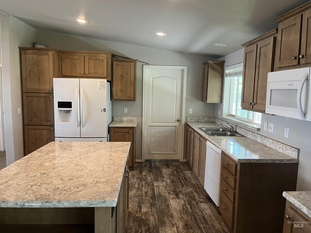kitchen featuring a sink, dark wood-style flooring, white appliances, and light countertops