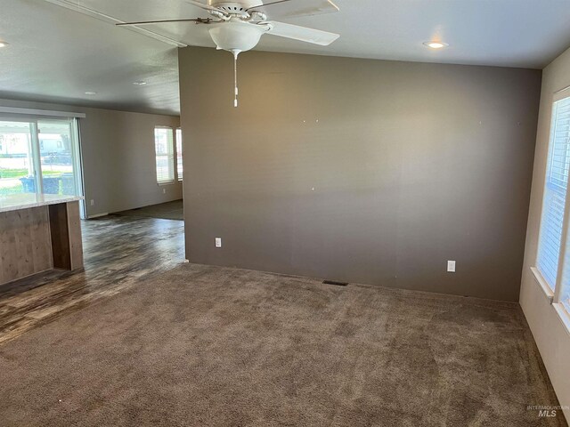 empty room with recessed lighting, ceiling fan, and dark colored carpet