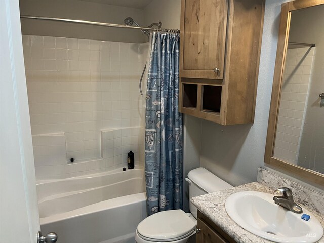 full bathroom with vanity, shower / bath combo with shower curtain, and toilet