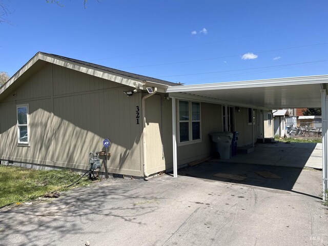 view of home's exterior featuring aphalt driveway and an attached carport