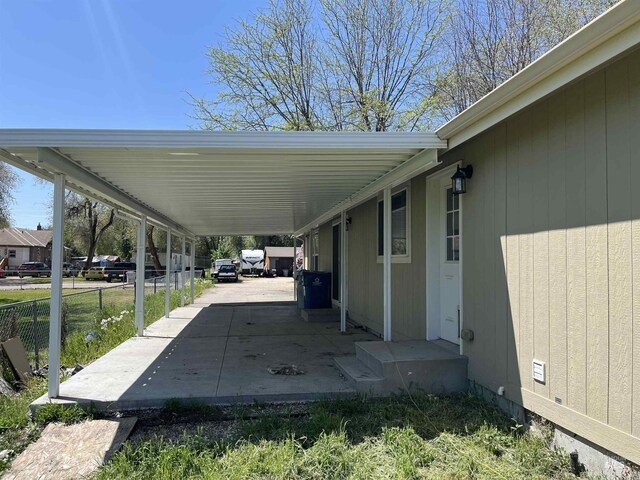 exterior space featuring fence and an attached carport