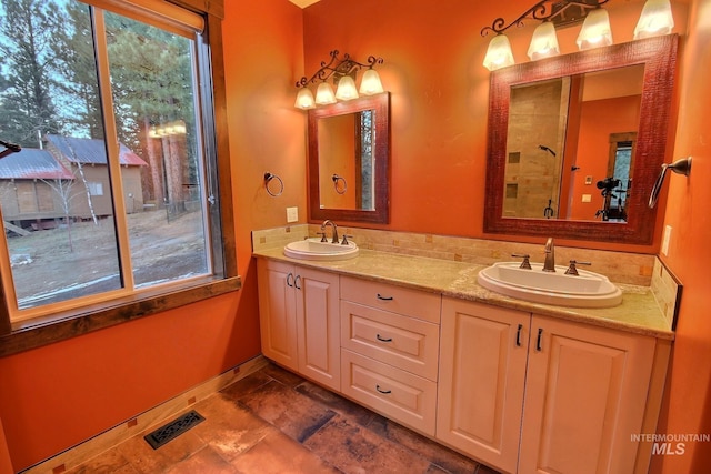 bathroom featuring a shower and vanity