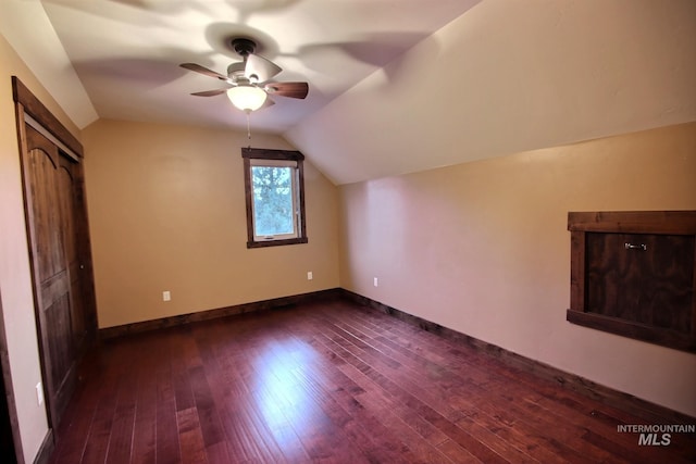 bonus room with ceiling fan, dark hardwood / wood-style floors, and lofted ceiling