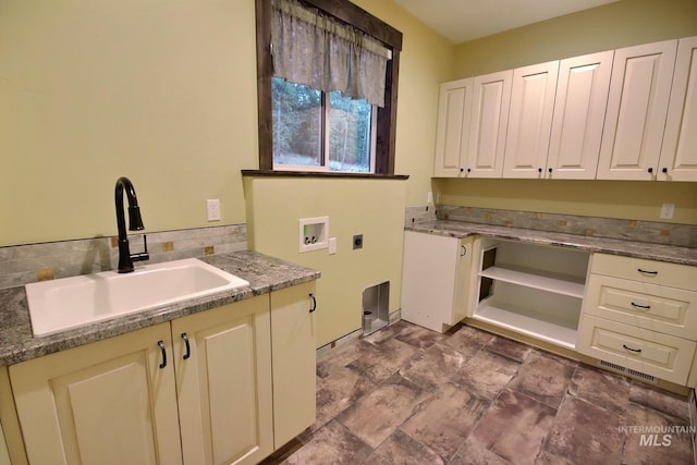 washroom featuring cabinets, washer hookup, sink, and electric dryer hookup