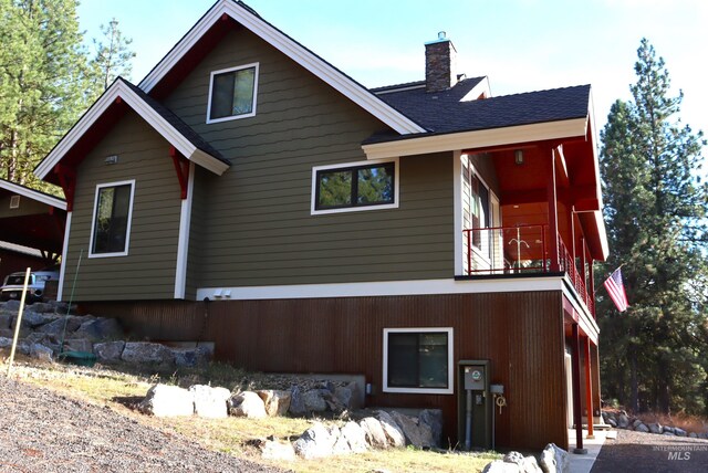 back of property featuring a balcony